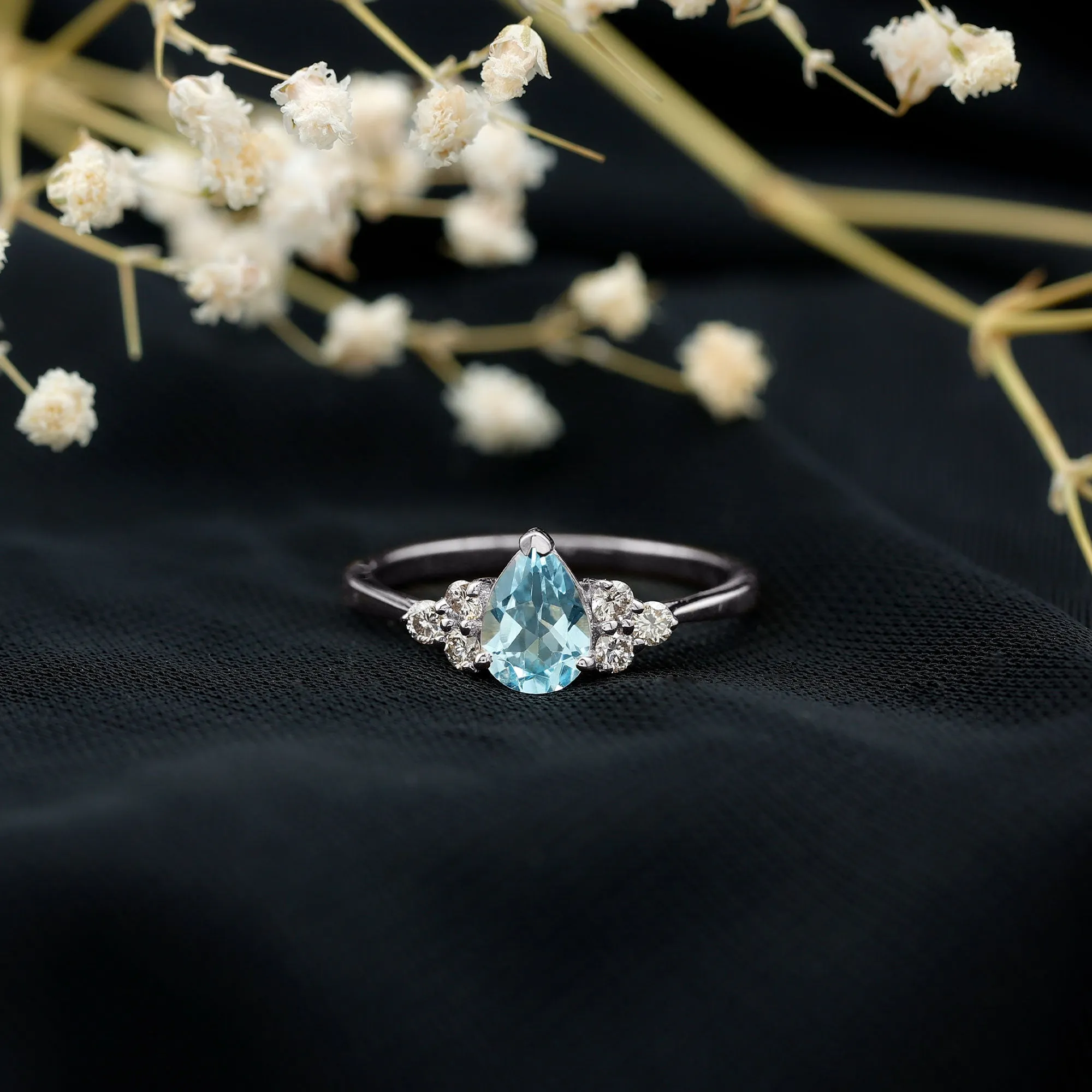 Claw Set Pear Cut Sky Blue Topaz Solitaire Ring with Diamond Trio